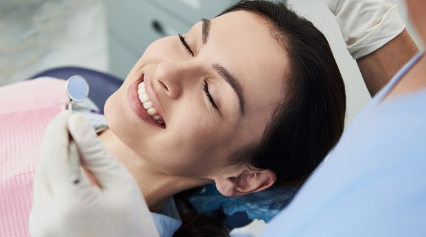 Female Getting Teeth Examined